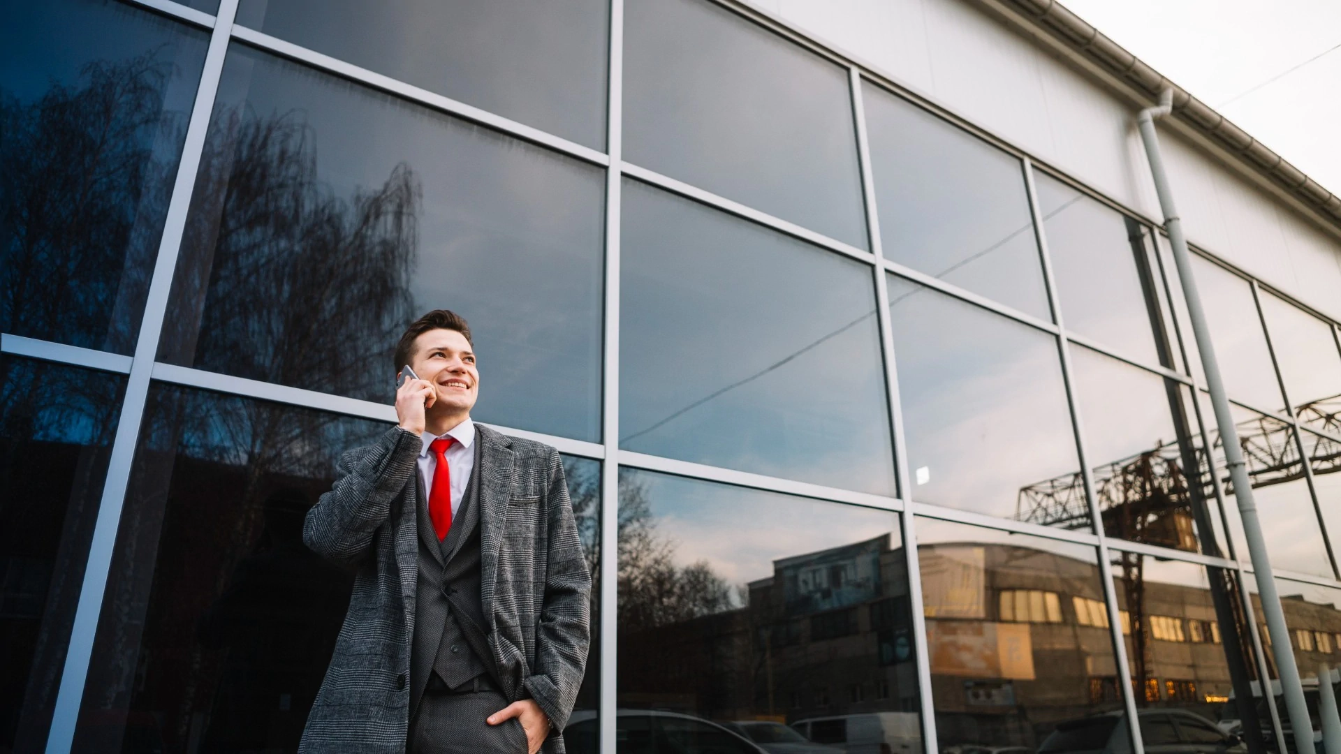 Man standing in from of office with tinted windows