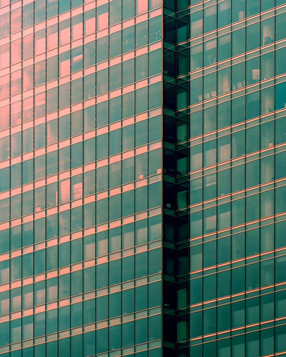 Modern glass skyscraper facade with geometric patterns